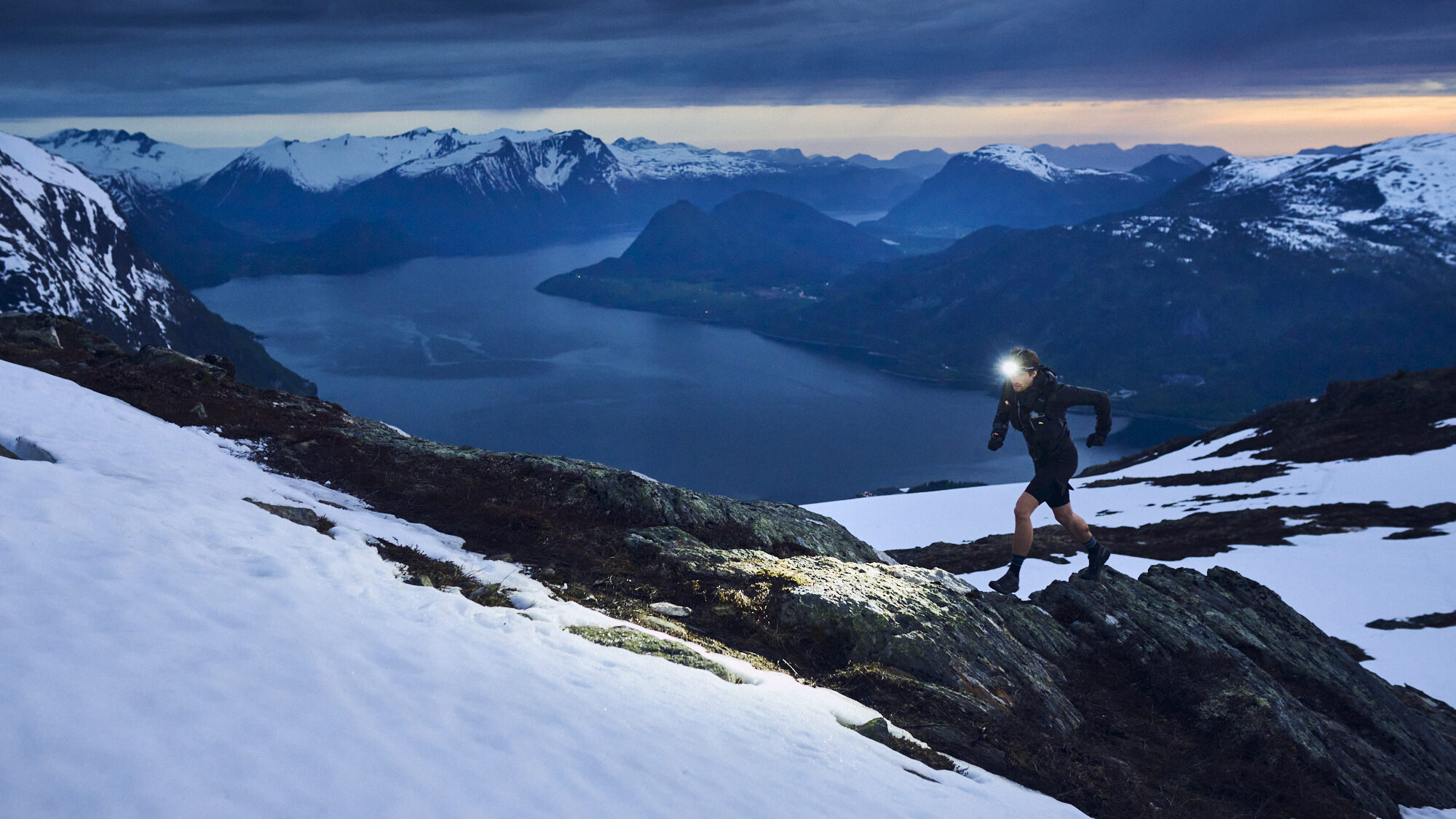 runner with headtorch in the snow